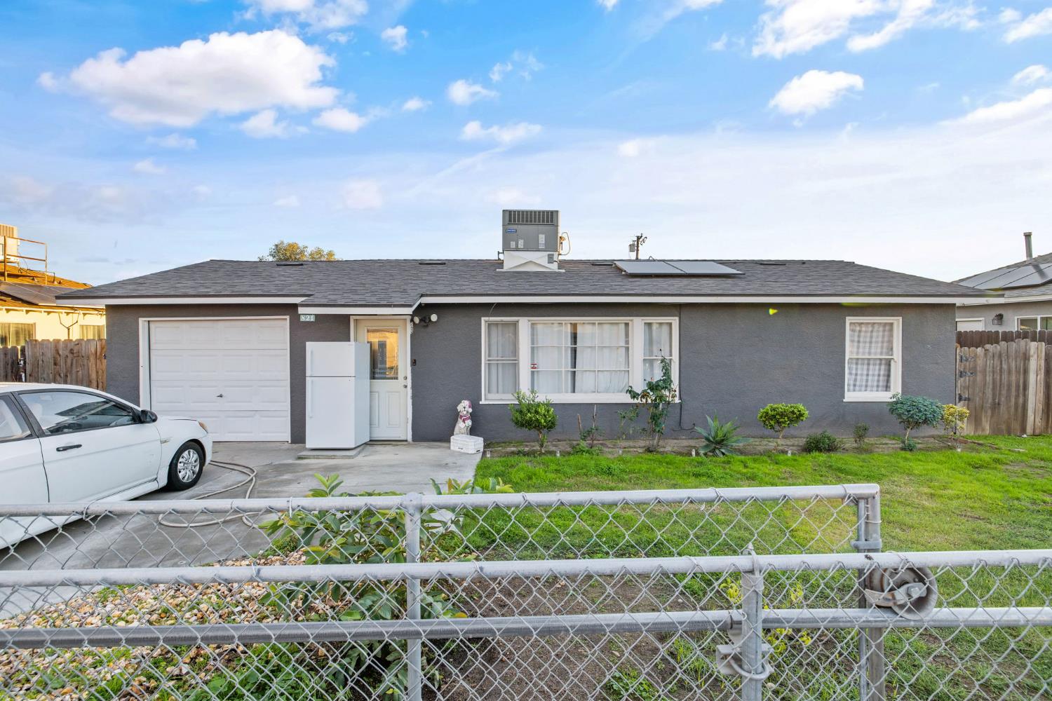 a front view of a house with a garden and plants