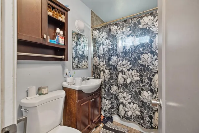 a bathroom with a sink toilet and shower
