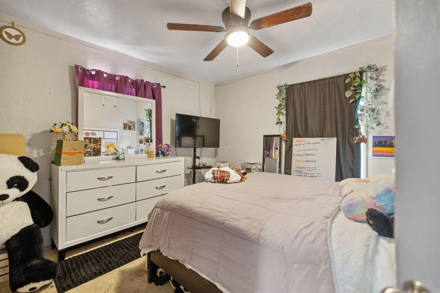 821 Lincoln Street Hanford, CA 93230 - Photo 14 of 22 a bedroom with a bed a computer on a desk and a closet