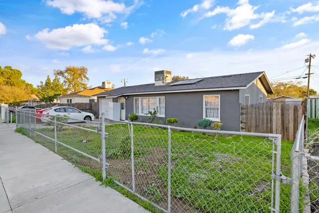 a view of a house with backyard and sitting area