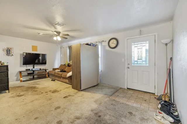 a view of a livingroom with furniture and a flat screen tv