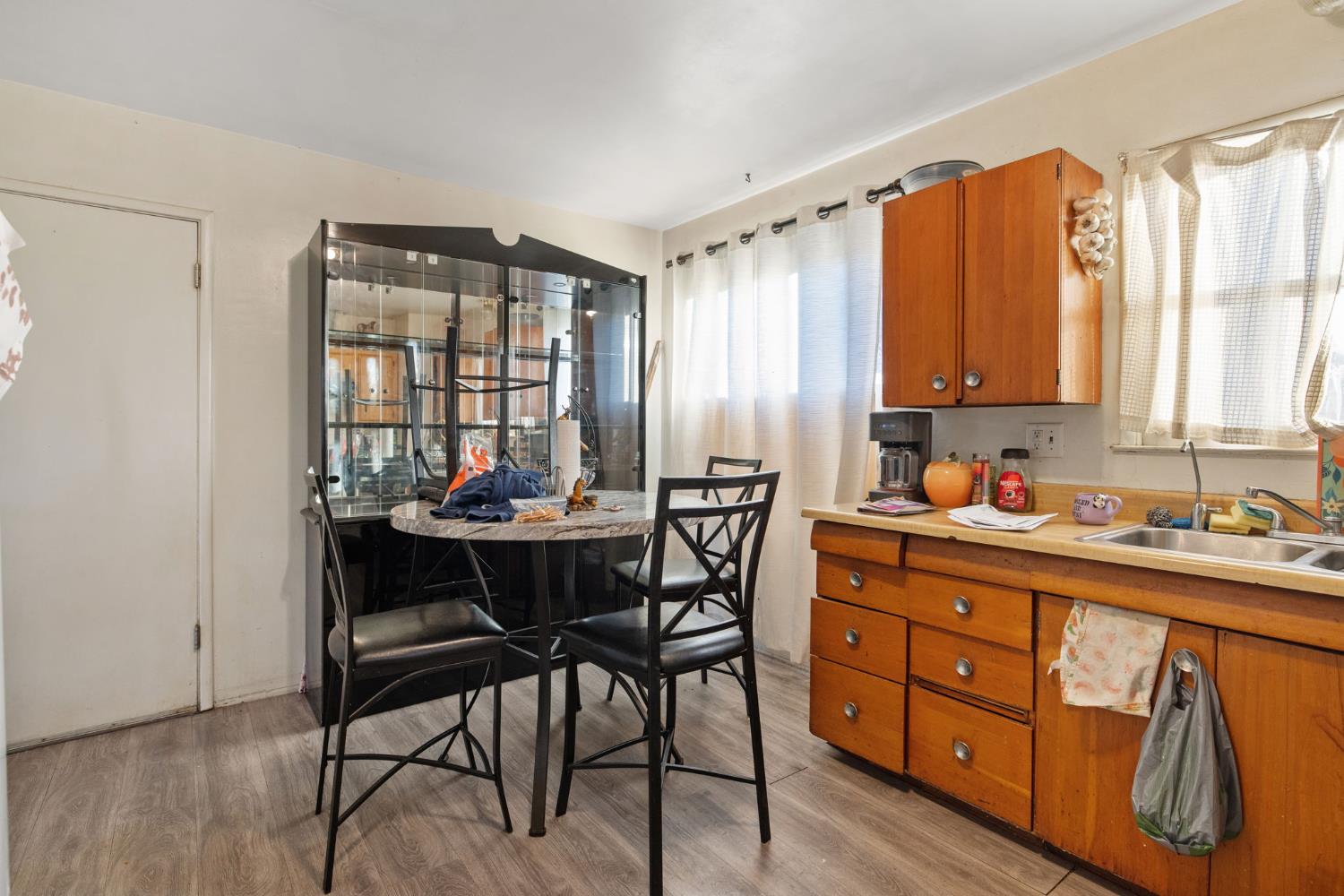 821 Lincoln Street Hanford, CA 93230 - Photo 8 of 22 a kitchen with stainless steel appliances a table and chairs in it