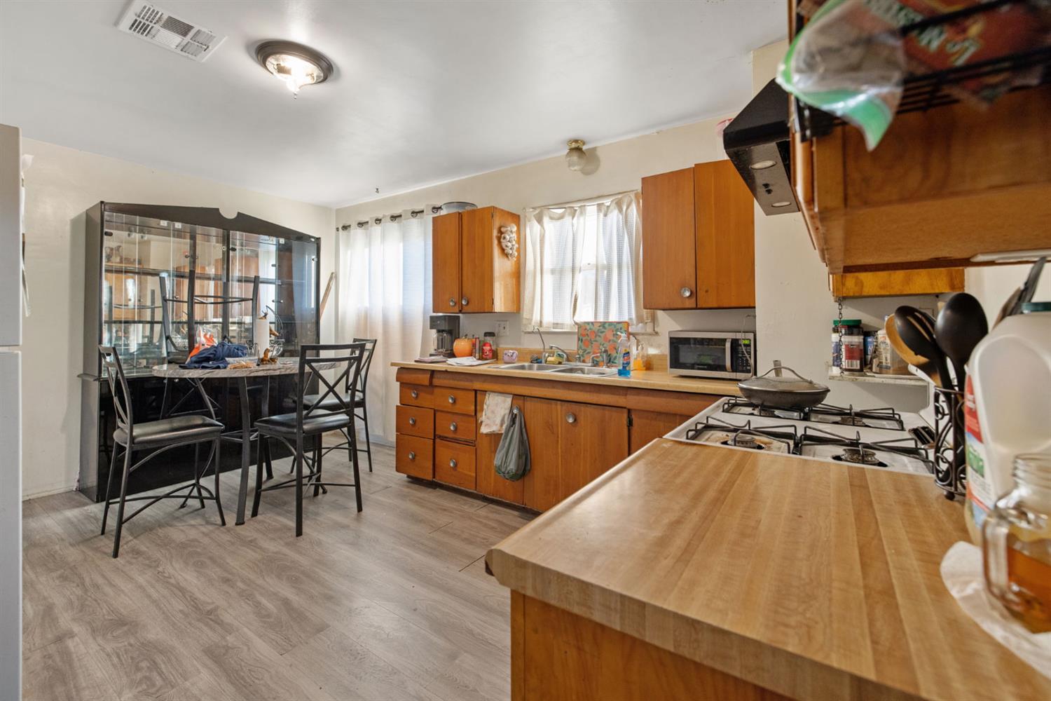 821 Lincoln Street Hanford, CA 93230 - Photo 10 of 22 a view of a kitchen with kitchen island a large window a sink and counter space