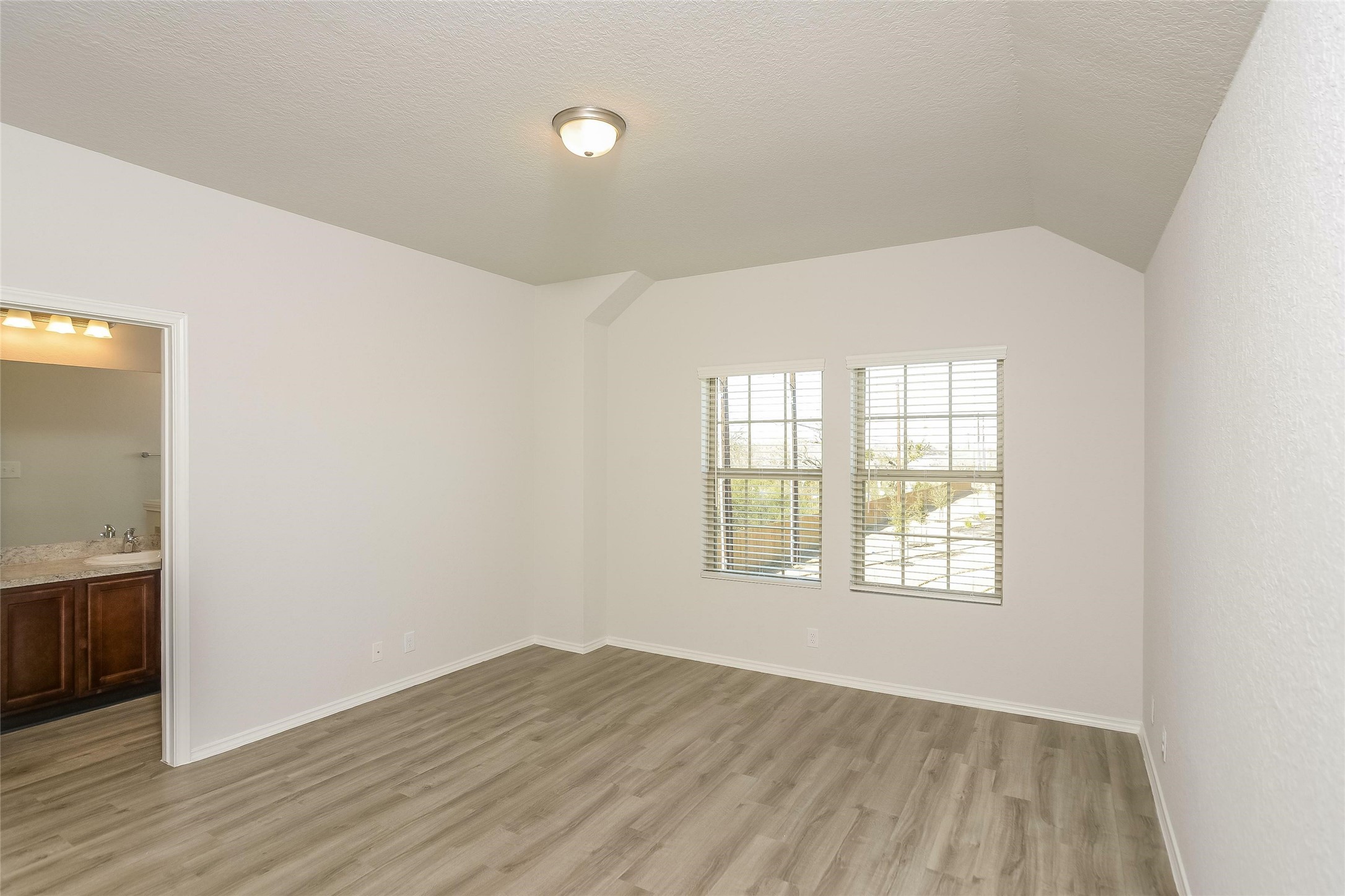 4815 Banyan Tree Trail Spring, TX 77373 - Photo 6 of 15 an empty room with wooden floor and windows