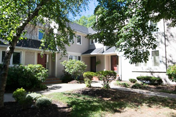 84 Jasper Lane, Unit 84 Randolph, MA 02368 - Photo 2 of 11 a front view of a house with a yard garage and outdoor seating