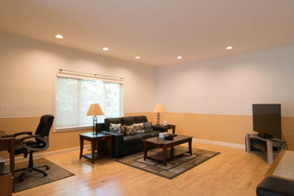 84 Jasper Lane, Unit 84 Randolph, MA 02368 - Photo 4 of 11 a living room with furniture a flat screen tv and a window
