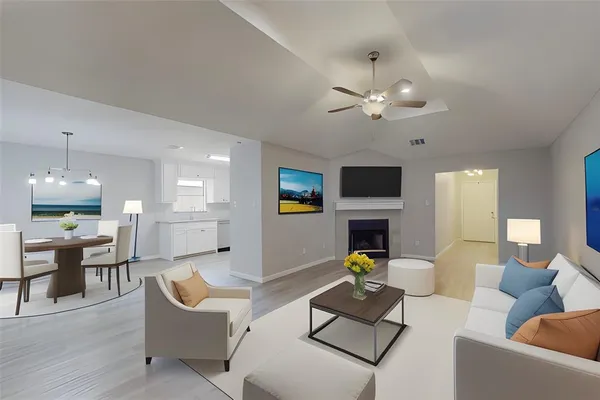 a living room with furniture a fireplace and a flat screen tv