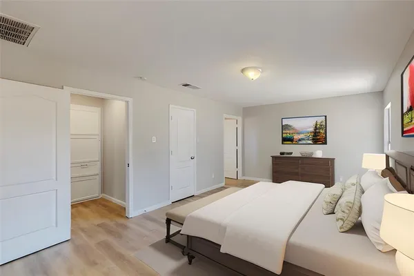 a bedroom with a bed and a view of living room