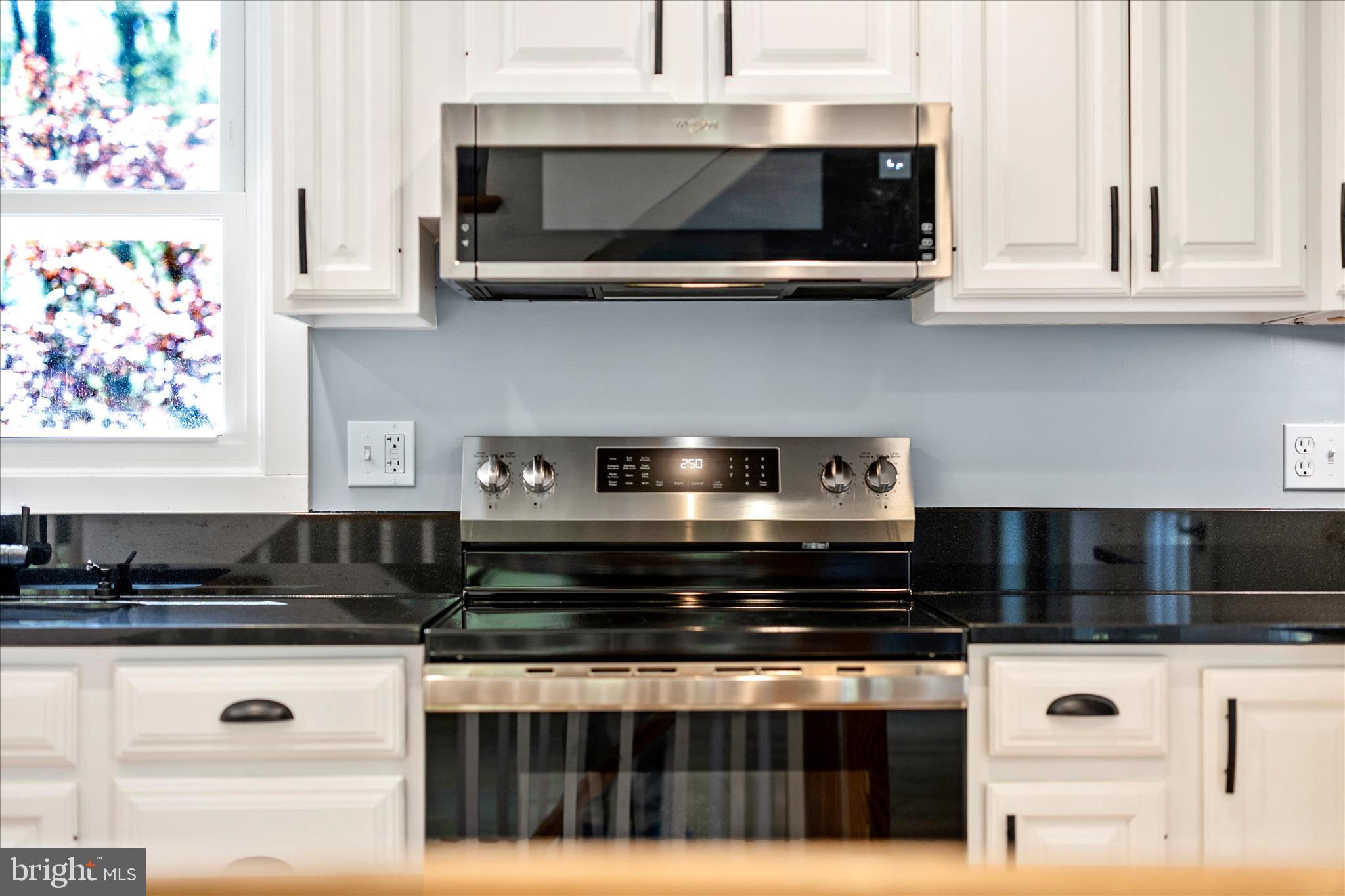 6518 Woodville Road Mount Airy, MD 21771 - Photo 11 of 53 a kitchen with a stove and cabinets