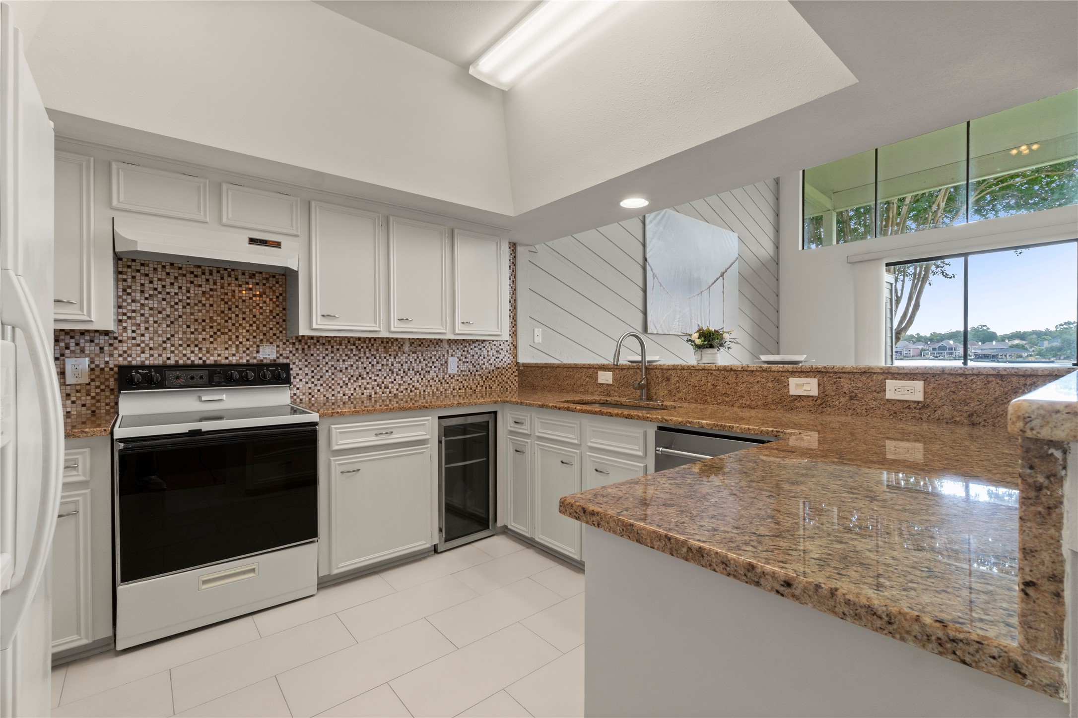 135 April Point Drive South Conroe, TX 77356 - Photo 14 of 46 a kitchen with granite countertop a sink stainless steel appliances and cabinets