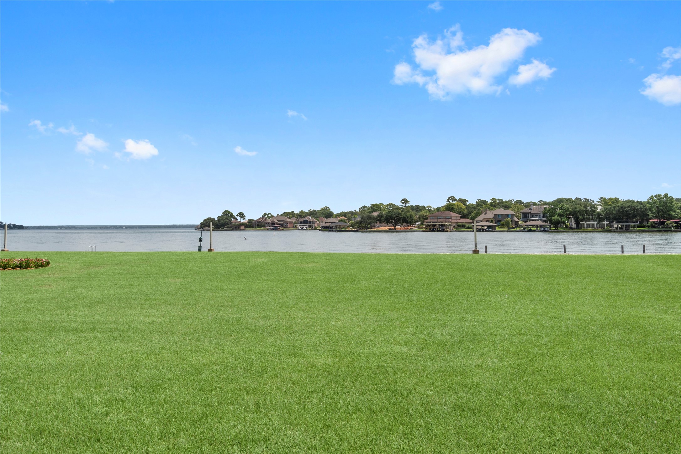 135 April Point Drive South Conroe, TX 77356 - Photo 31 of 46 a view of a lake with houses in the back