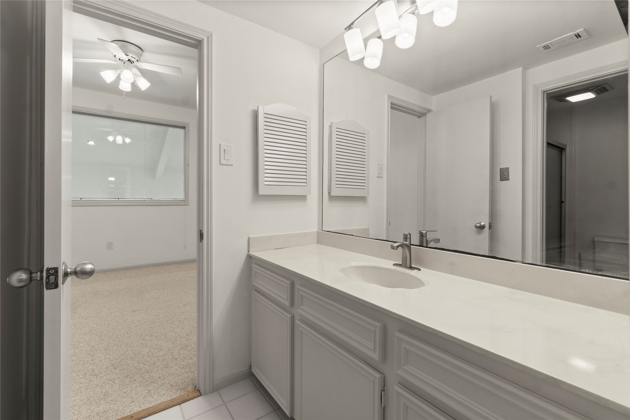 135 April Point Drive South Conroe, TX 77356 - Photo 4 of 46 a bathroom with a sink a vanity and a mirror