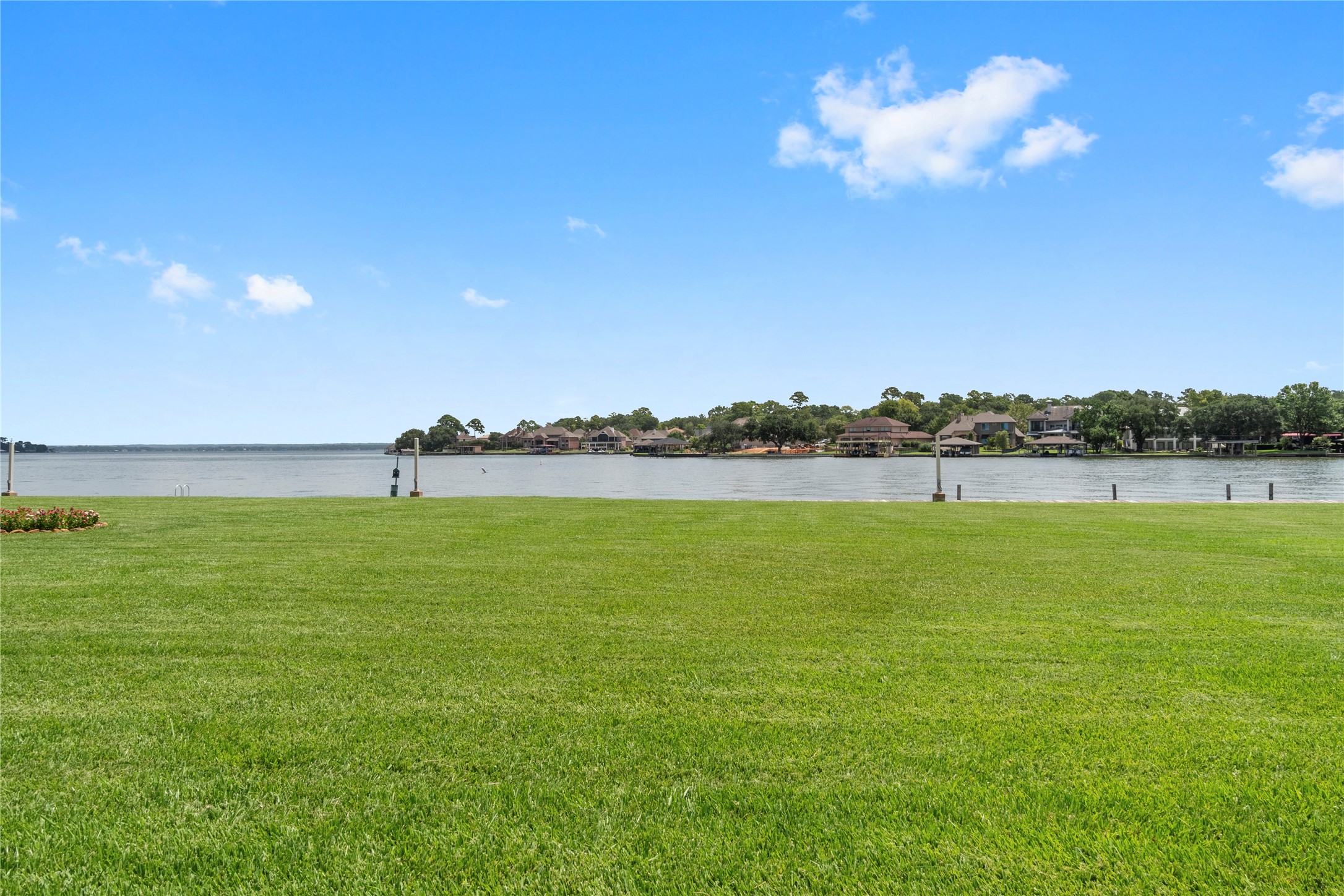 135 April Point Drive South Conroe, TX 77356 - Photo 44 of 46 a view of a lake with houses in the background