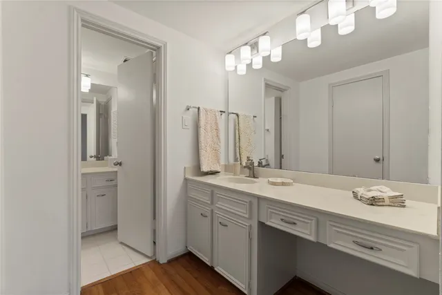 a bathroom with a double vanity sink mirror and shower