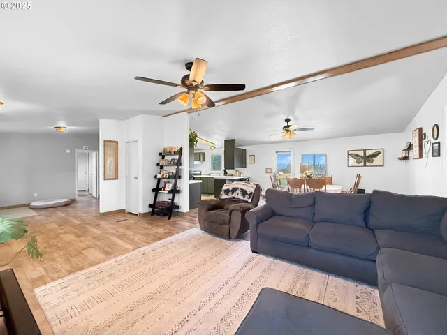 a living room with furniture and kitchen view
