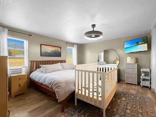 a bedroom with a bed and a chandelier