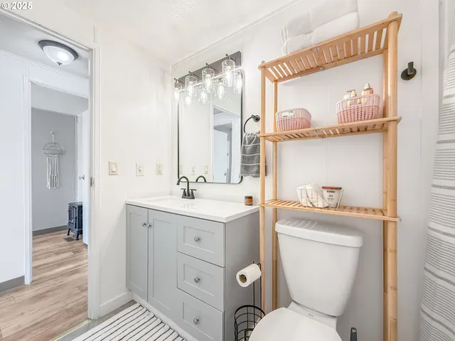 a bathroom with a toilet a sink and a mirror
