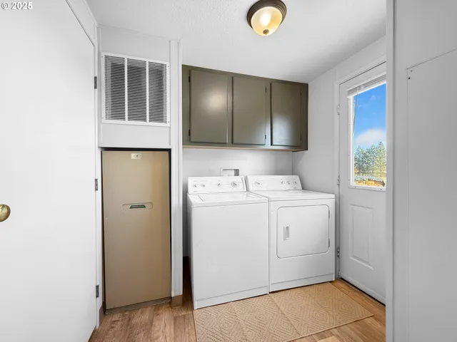 a utility room with cabinets washer and dryer