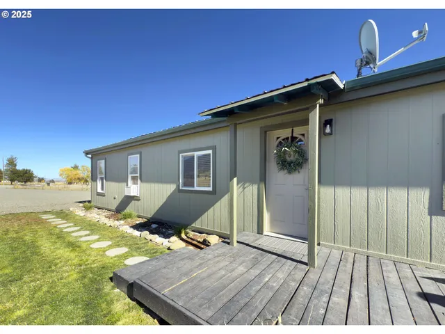 a view of a deck with wooden floor and seating space