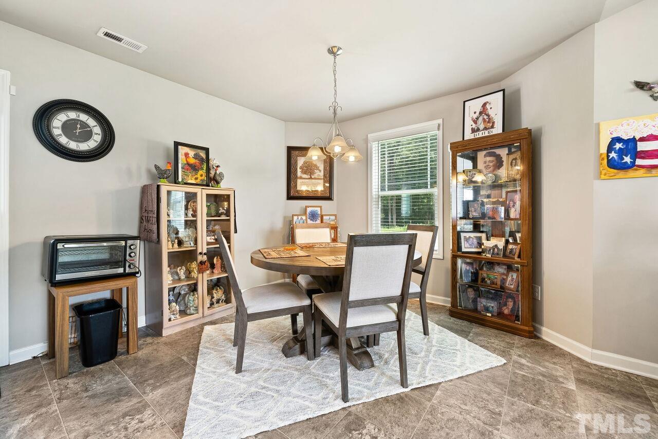 169 Willow Ridge Circle Willow Spring, NC 27592 - Photo 11 of 30 a dining room with furniture window and wooden floor