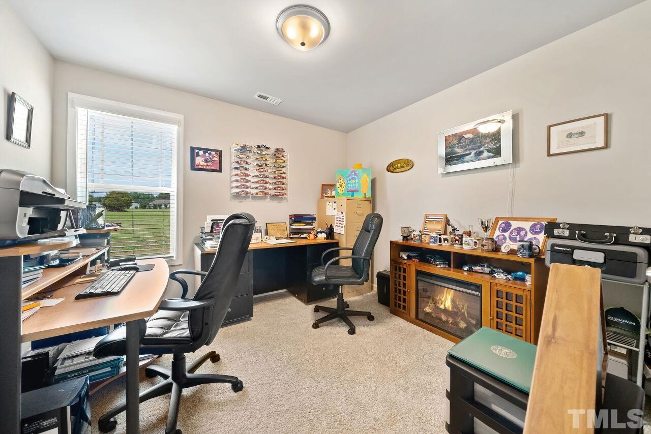 169 Willow Ridge Circle Willow Spring, NC 27592 - Photo 12 of 30 a view of a workspace with furniture and a window