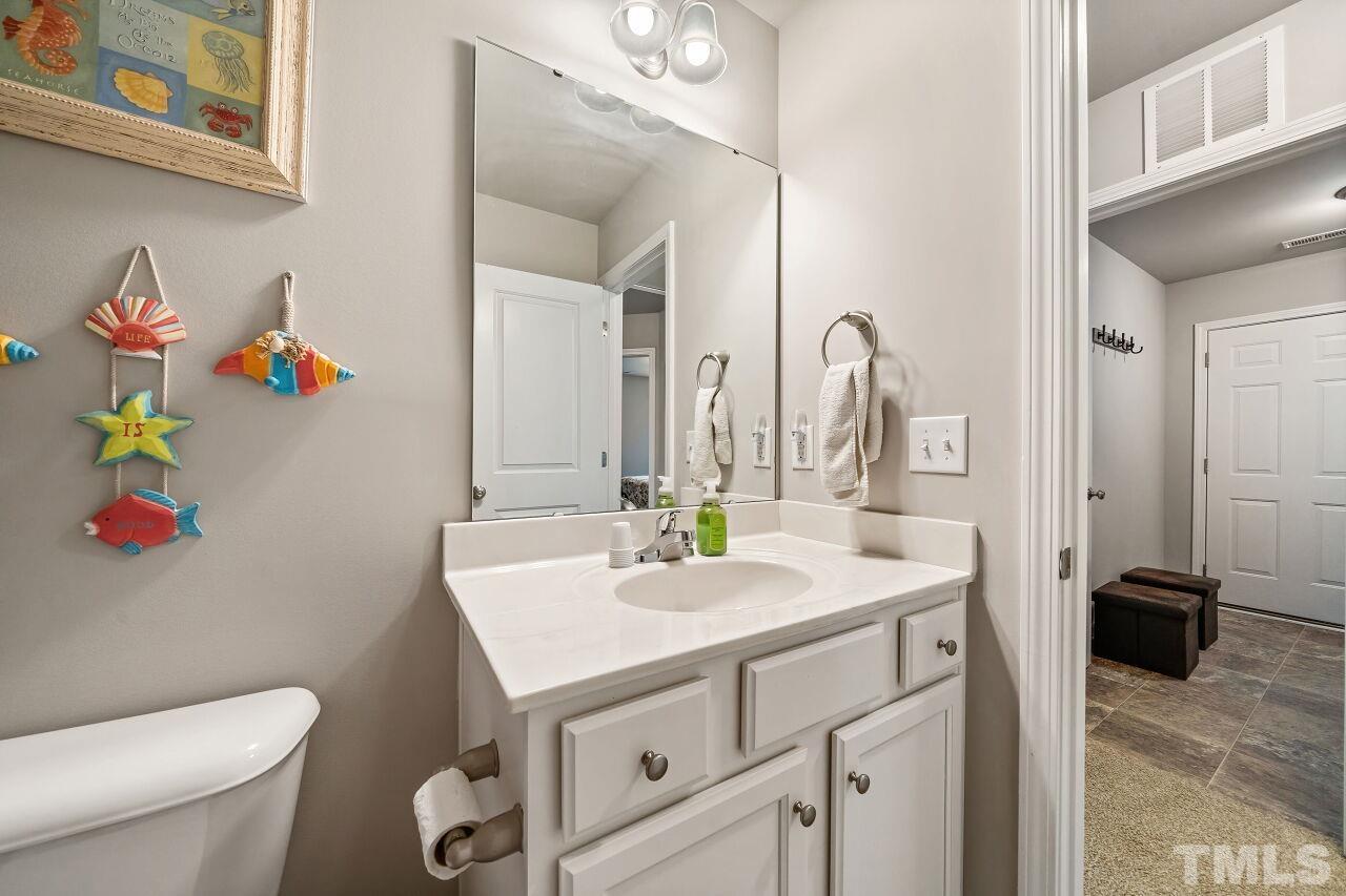 169 Willow Ridge Circle Willow Spring, NC 27592 - Photo 17 of 30 a bathroom with a sink a toilet and a mirror