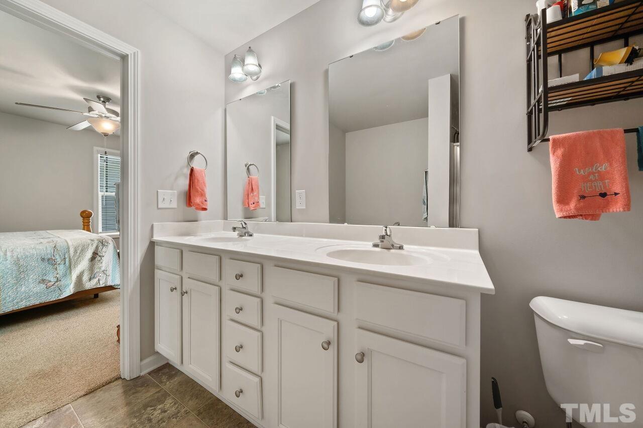 169 Willow Ridge Circle Willow Spring, NC 27592 - Photo 21 of 30 a bathroom with a double vanity sink and a mirror