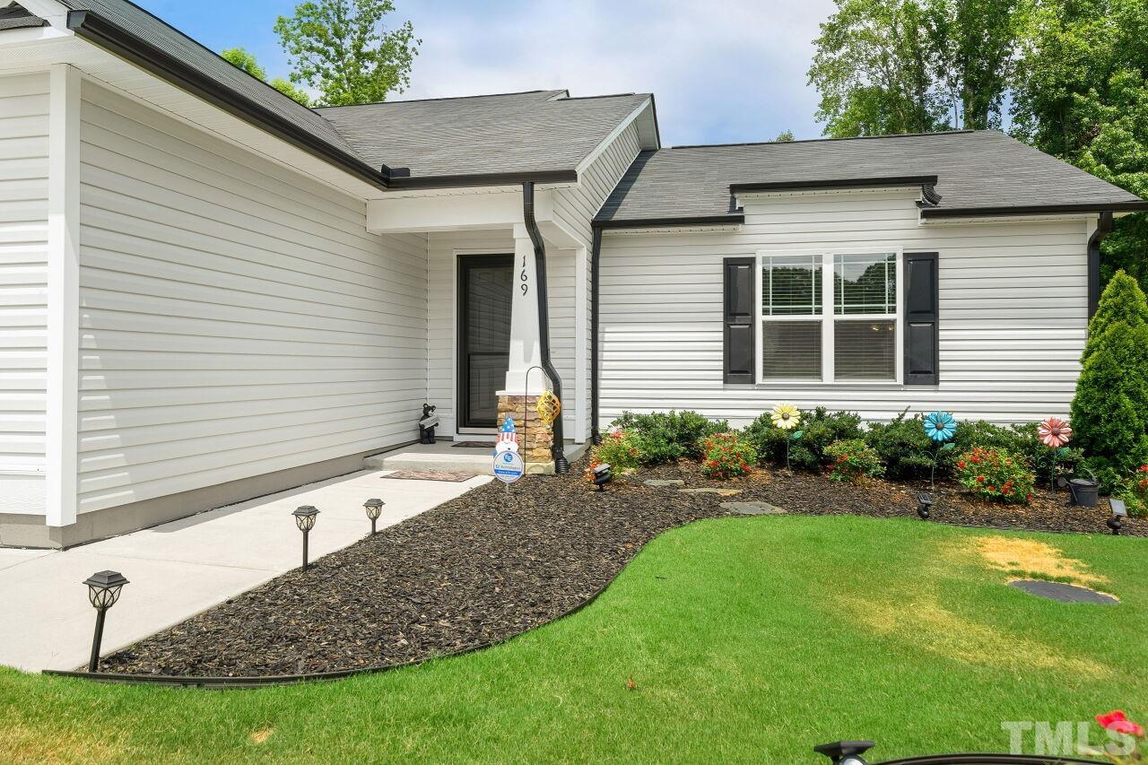 169 Willow Ridge Circle Willow Spring, NC 27592 - Photo 24 of 30 a front view of a house with garden