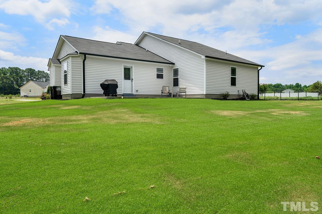 169 Willow Ridge Circle Willow Spring, NC 27592 - Photo 26 of 30 a front view of house with a garden and deck