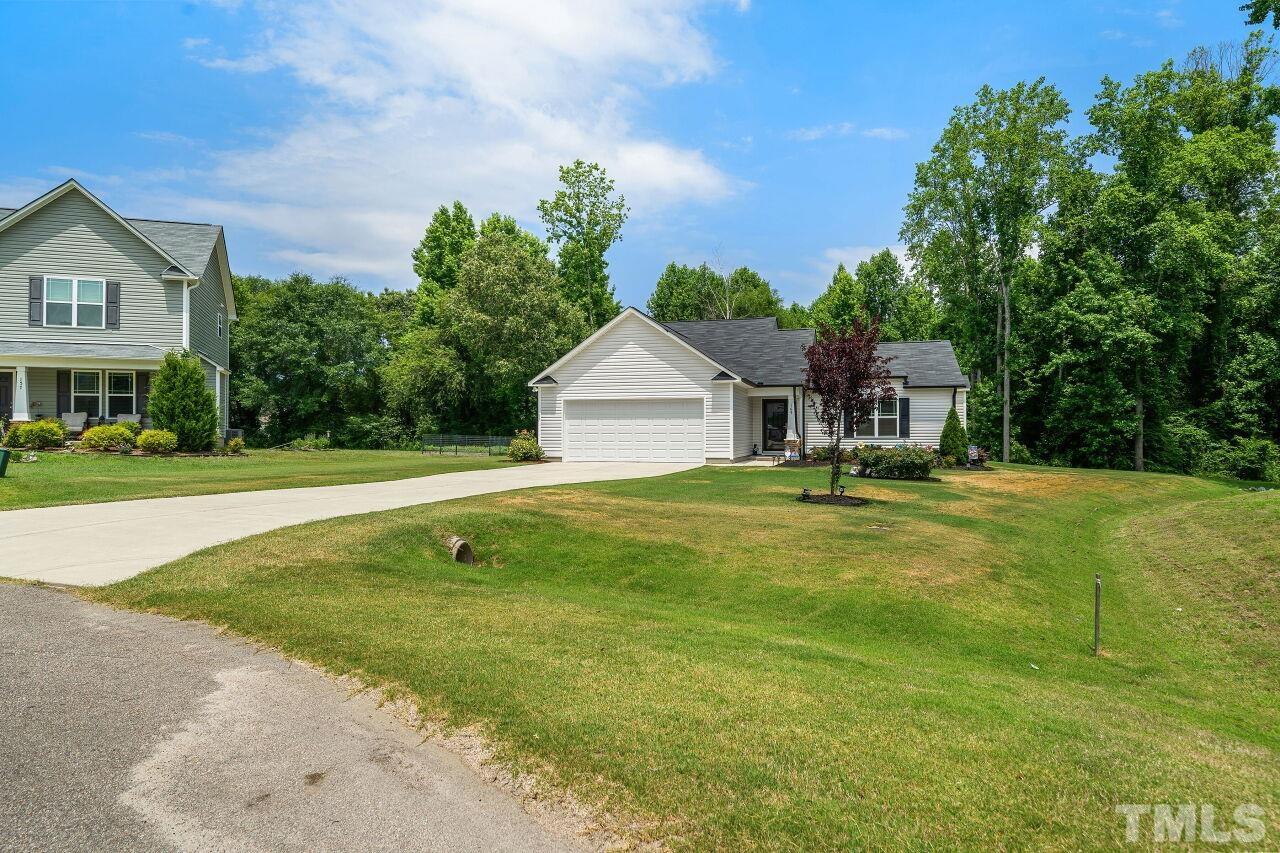 169 Willow Ridge Circle Willow Spring, NC 27592 - Photo 29 of 30 a house view with swimming pool and trees in the background