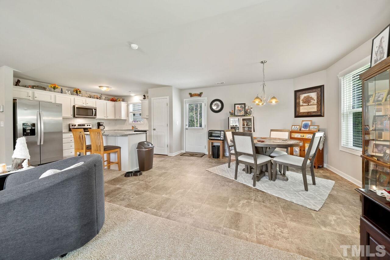 169 Willow Ridge Circle Willow Spring, NC 27592 - Photo 3 of 30 a living room with stainless steel appliances kitchen island granite countertop furniture and a kitchen view