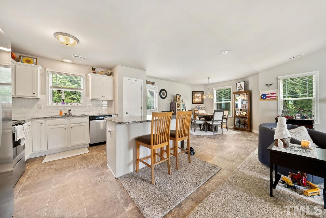 169 Willow Ridge Circle Willow Spring, NC 27592 - Photo 4 of 30 a living room with furniture and a dining table with kitchen view