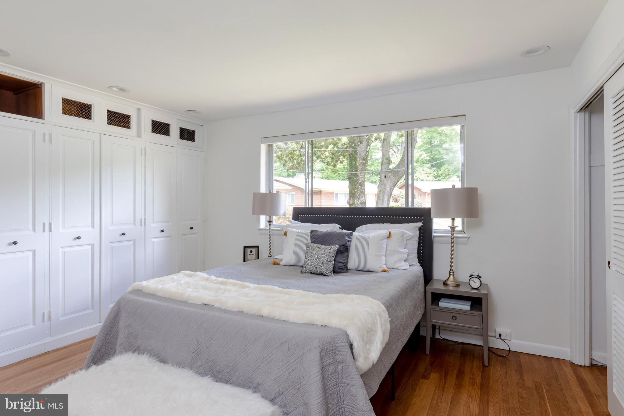 8221 West Beach Terrace Northwest Washington, DC 20012 - Photo 10 of 23 Two walls of closets in primary bedroom
