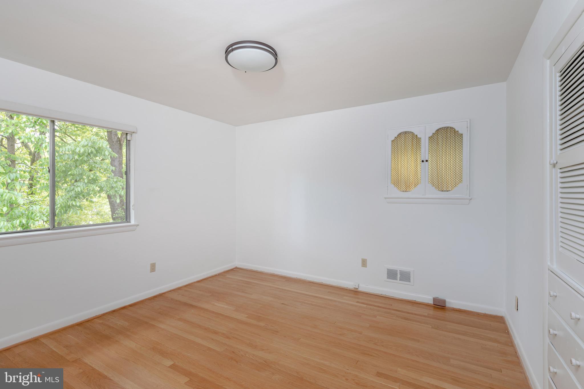 8221 West Beach Terrace Northwest Washington, DC 20012 - Photo 12 of 23 Two exposures and built in drawers in this bedroom