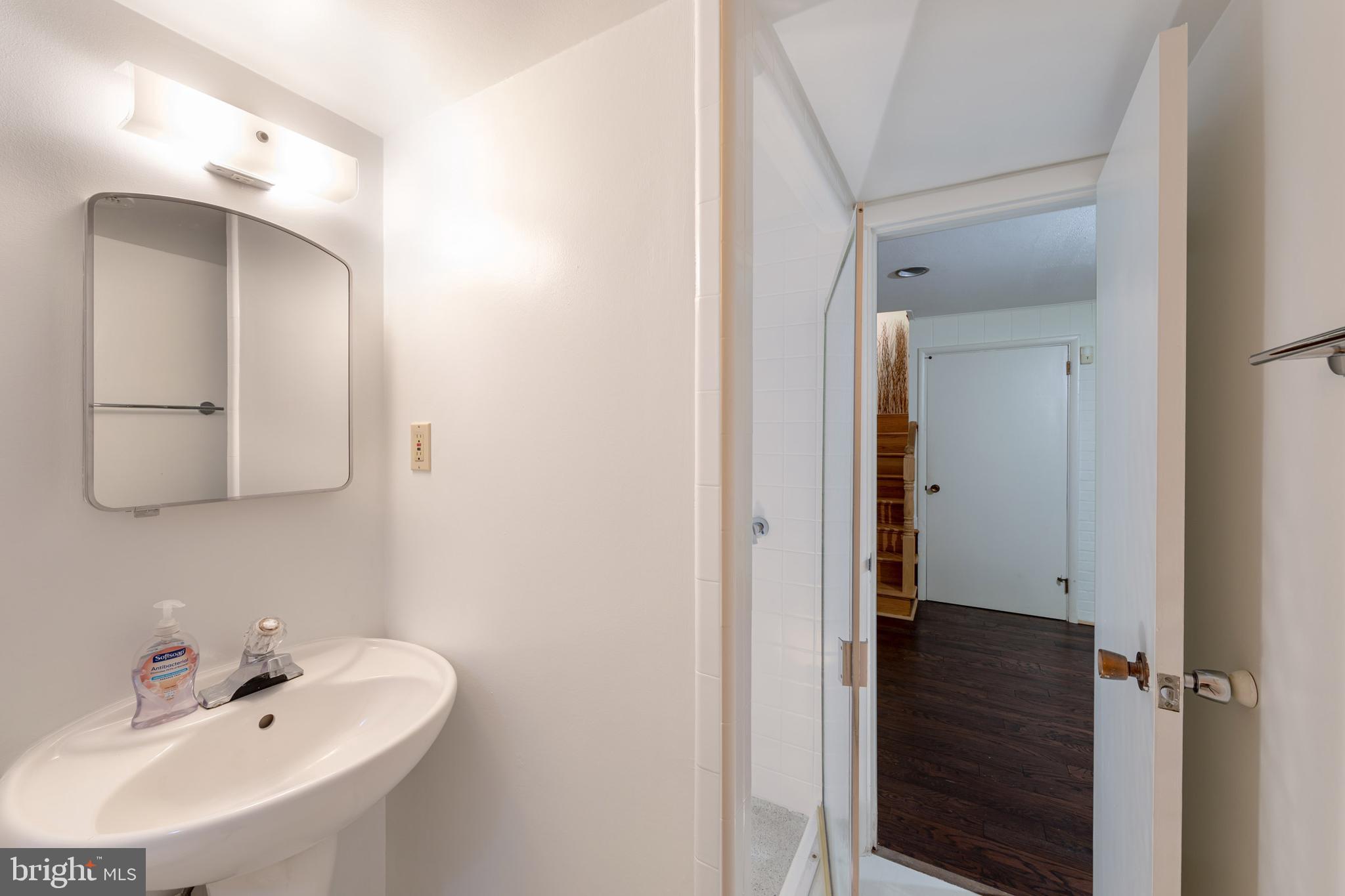 8221 West Beach Terrace Northwest Washington, DC 20012 - Photo 18 of 23 Clean white bathroom with shower stall