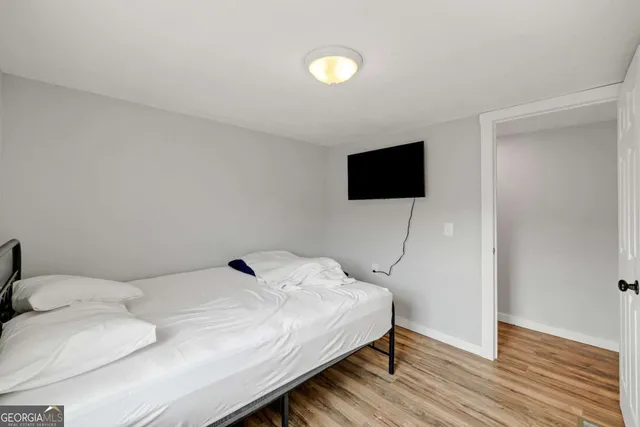 a bedroom with a bed and a flat screen tv