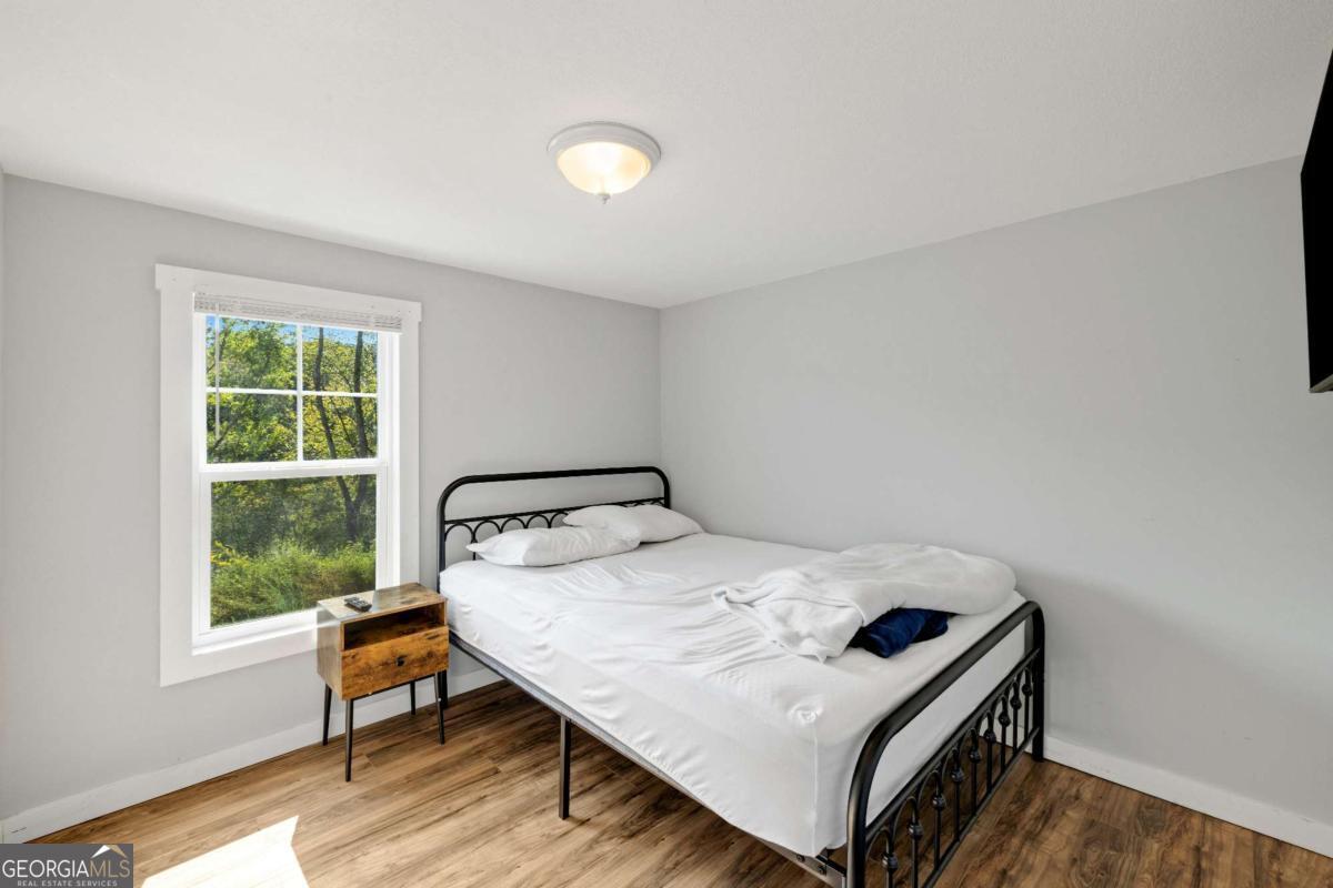 1330 Old Northcutt Road Ellijay, GA 30540 - Photo 17 of 21 a bedroom with a bed and a window