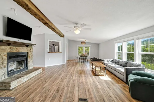 a living room with furniture fireplace and flat screen tv