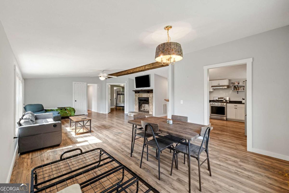 1330 Old Northcutt Road Ellijay, GA 30540 - Photo 5 of 21 a view of a dining room with furniture wooden floor and chandelier