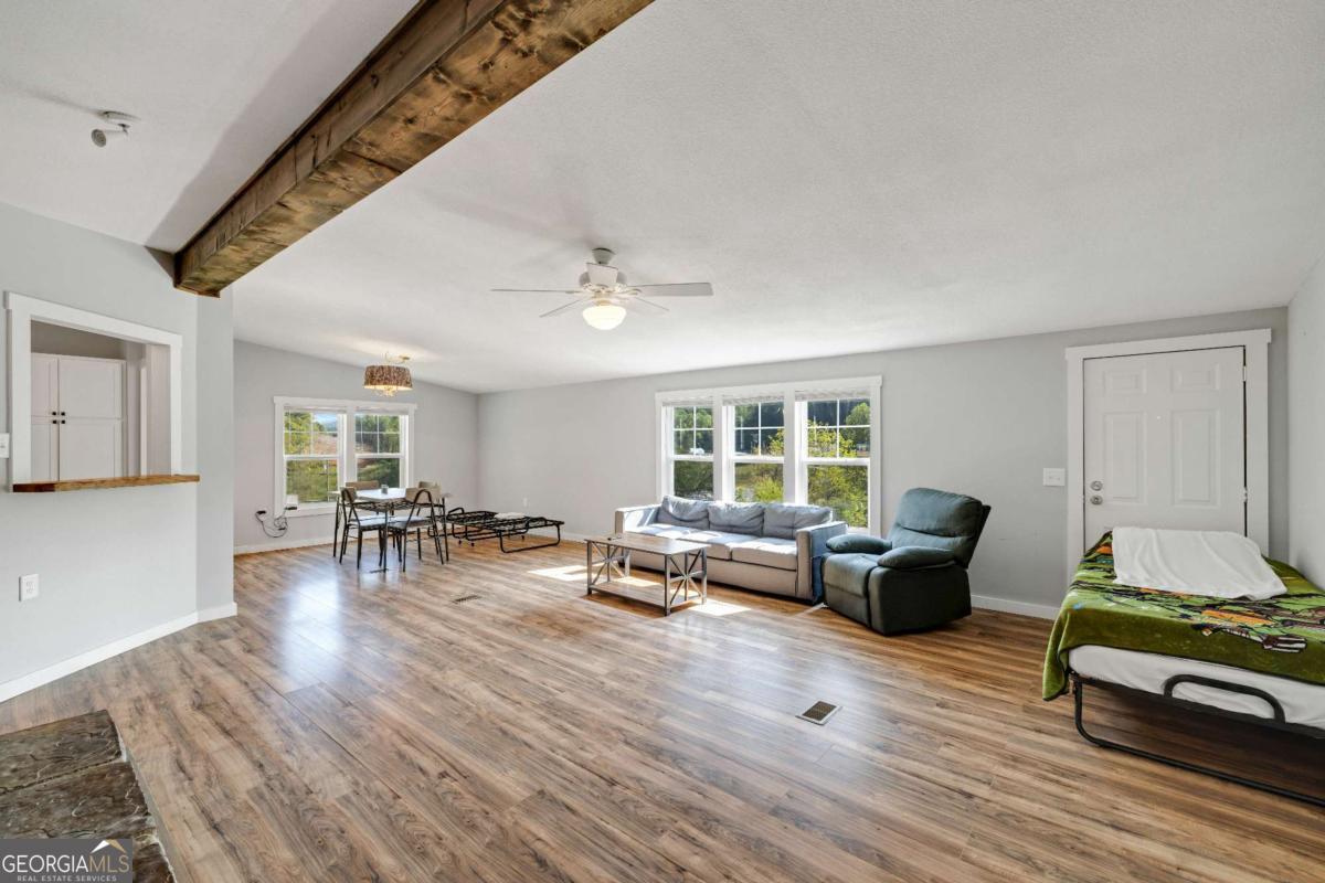 1330 Old Northcutt Road Ellijay, GA 30540 - Photo 8 of 21 a living room with furniture and a large window
