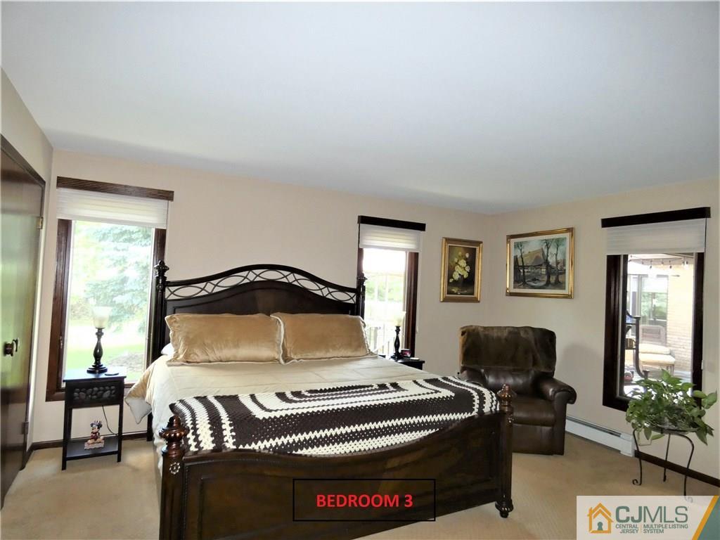 25 Runnymede Road Colonia, NJ 07067 - Photo 14 of 26 a bedroom with a bed and a chair