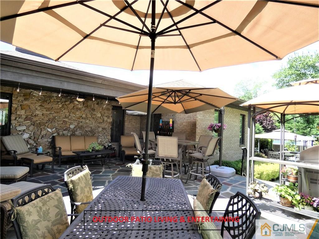 25 Runnymede Road Colonia, NJ 07067 - Photo 22 of 26 a outdoor living space with patio furniture and a potted plant