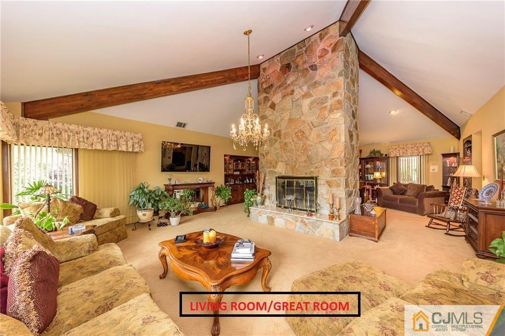 25 Runnymede Road Colonia, NJ 07067 - Photo 4 of 26 a living room with furniture and a flat screen tv