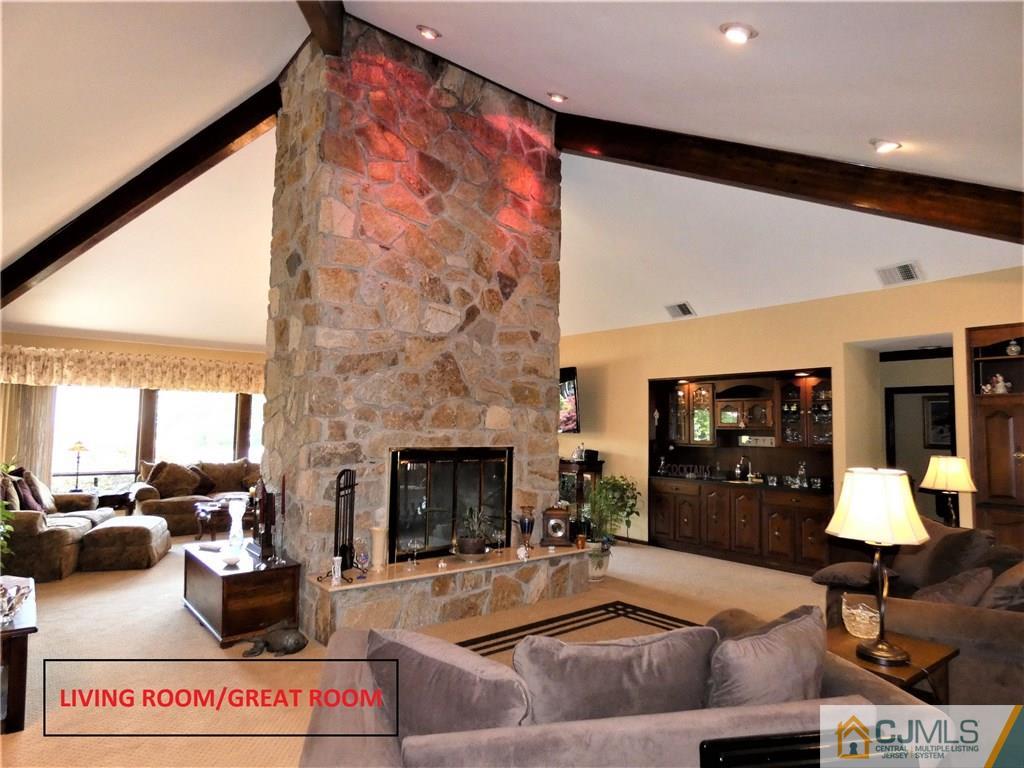 25 Runnymede Road Colonia, NJ 07067 - Photo 7 of 26 a living room with furniture and a fireplace
