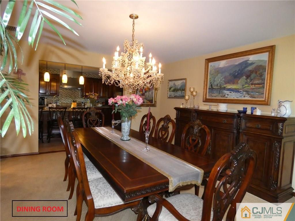 25 Runnymede Road Colonia, NJ 07067 - Photo 8 of 26 a view of a dining room with furniture and chandelier