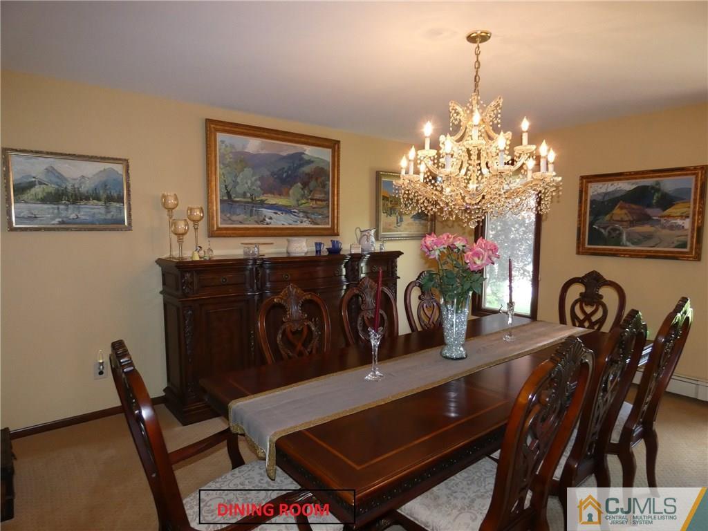 25 Runnymede Road Colonia, NJ 07067 - Photo 9 of 26 a view of a dining room with furniture and chandelier