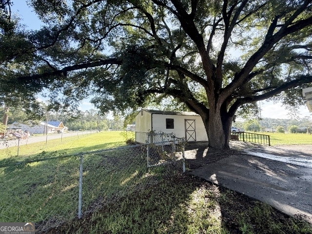451 Lambs Bridge Road Swainsboro, GA 30401 - Photo 20 of 23 a view of a house with a yard and sitting area