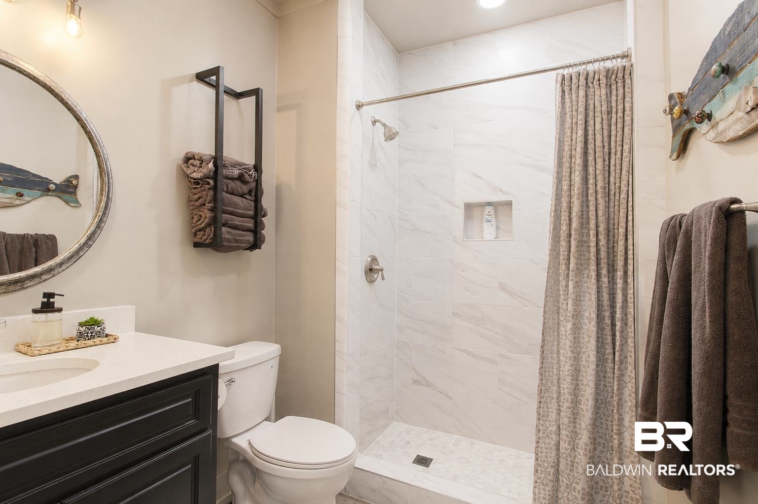 9825 Wolf Creek Ridge Elberta, AL 36530 - Photo 14 of 76 Bathroom featuring a shower with white marble-look tile surround, a built-in shower niche, and a contrasting pebble-style tile shower pan