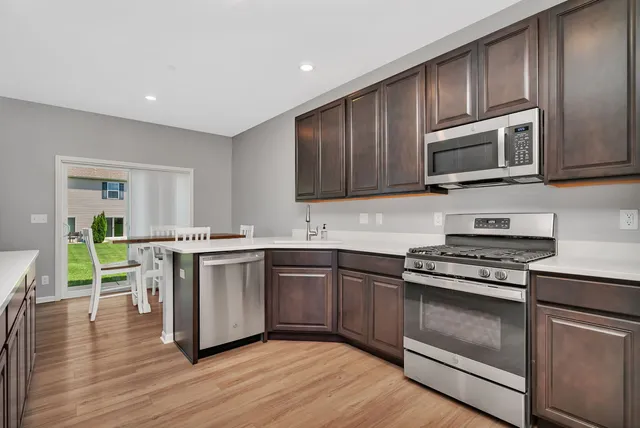 a kitchen with wooden cabinets and stainless steel appliances