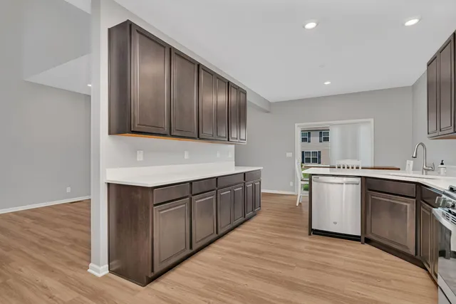 a kitchen with granite countertop wooden cabinets and white appliances